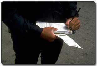 Cop writing a ticket for a Missouri traffic law violation 